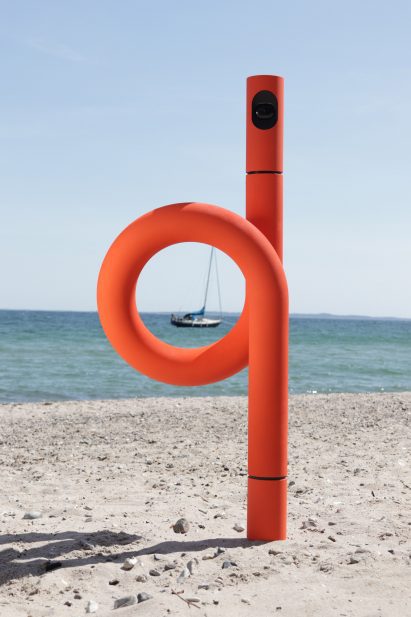 Loopy orange surveillance camera on a beach