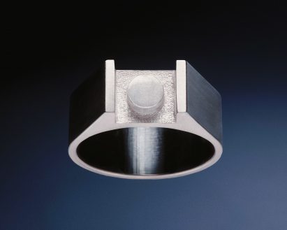 Silver rings with central plate shaped like Lego tile. Photo courtesy of Anna Hadaier