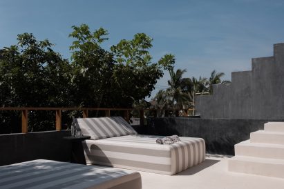 Comfy loungers set against dark grey chukum walls