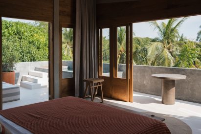 Guest room looking out to a wraparound terrace and plunge pool