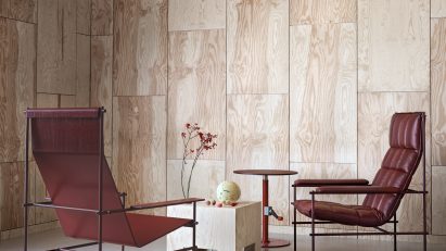 Photo of red leather chairs, a wooden, cube-shaped coffee tables and a red metal side table