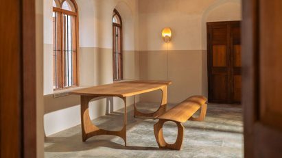Photo of a wooden curved table and bench