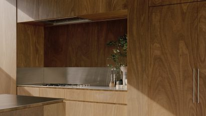 Timber kitchen featuring stainless countertop by Fisher & Paykel