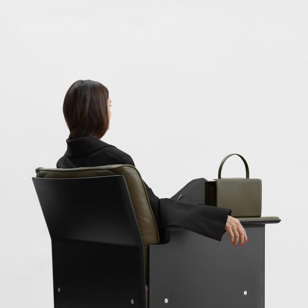 Photo of person sat on a chair, facing away
