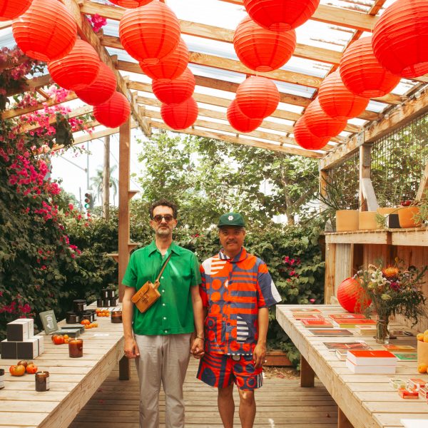 Photo of two people under red paper lanterns