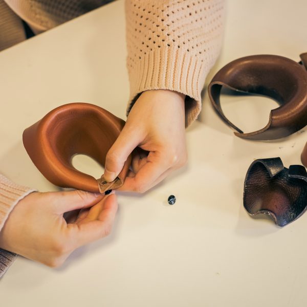 Photo of hands working with leather