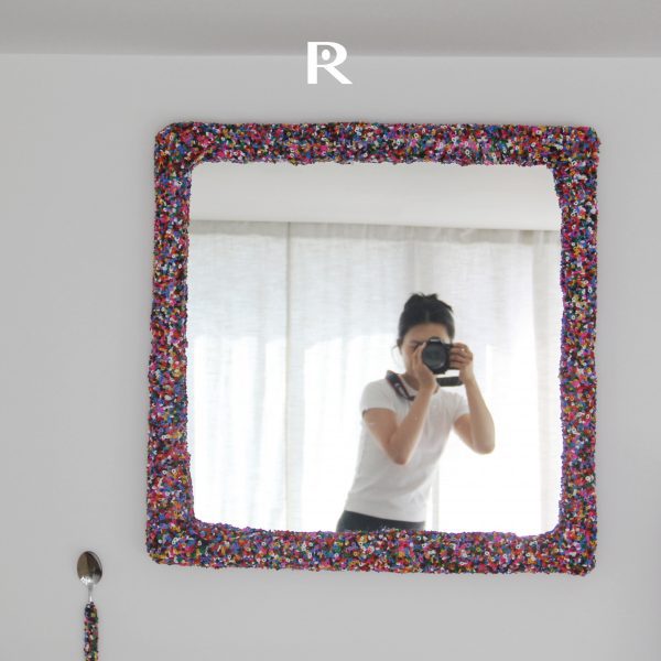 Photo of a person taking a picture of themselves in a mirror