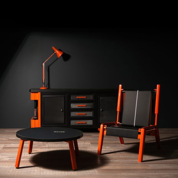 Photo of black and orange furniture: a coffee table, chair, lamp and console table
