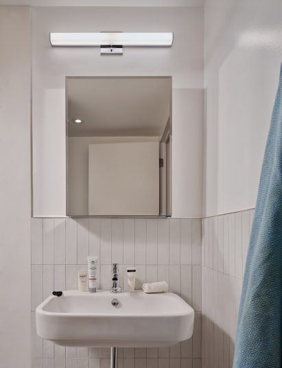 Bathroom sink with a mirror and a light above
