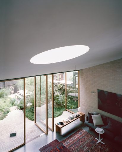Australian cottage extension with rotating glass doors by Lovell Burton