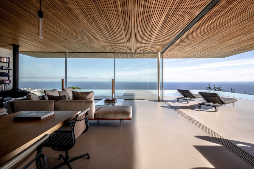 Living room with glazed facades at Barcelona House by Ström Architects in Spain