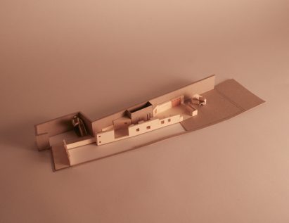 a photograph of an architectural model in tones of brown and beige