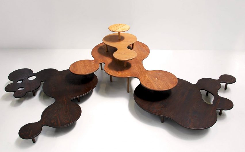 a photograph of circular, abstract-shaped tables in tones of brown