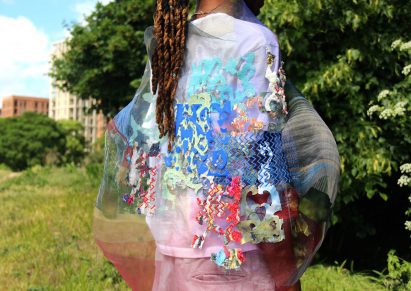 a photograph of a person wearing garments in tones of pink, blue, red and green
