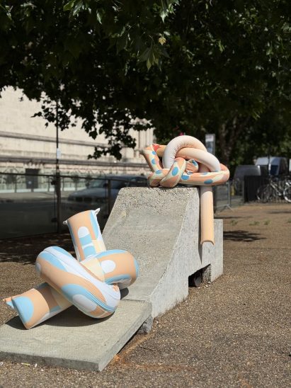 a photograph of sculptures displayed in the street