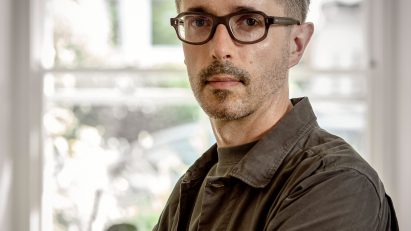 a photograph of a person in a brown shirt