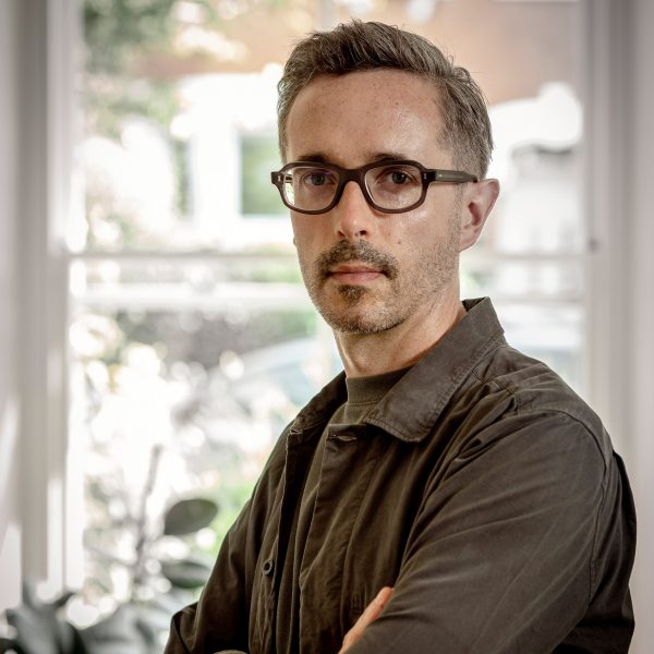a photograph of a person in a brown shirt