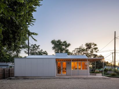 Exterior of a single-storey, metal-clad building at dusk