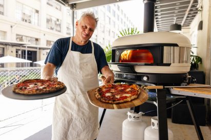 Man holding two pizzas