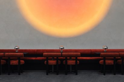 Linear banquette and dining chairs with burnt-orange velvet upholstery