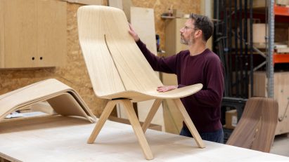 Man with plywood chair