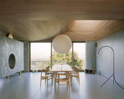 Dining room with a Danby marble fireplace to one side and a skylight above