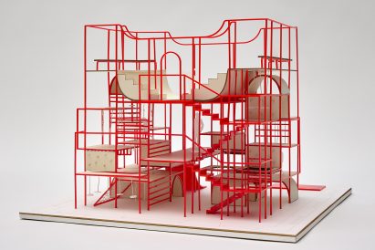 a photograph of an architectural model in tones of red