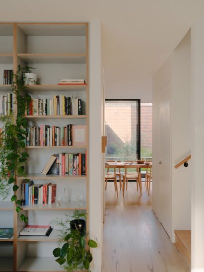 White home interior with wooden bookshelves
