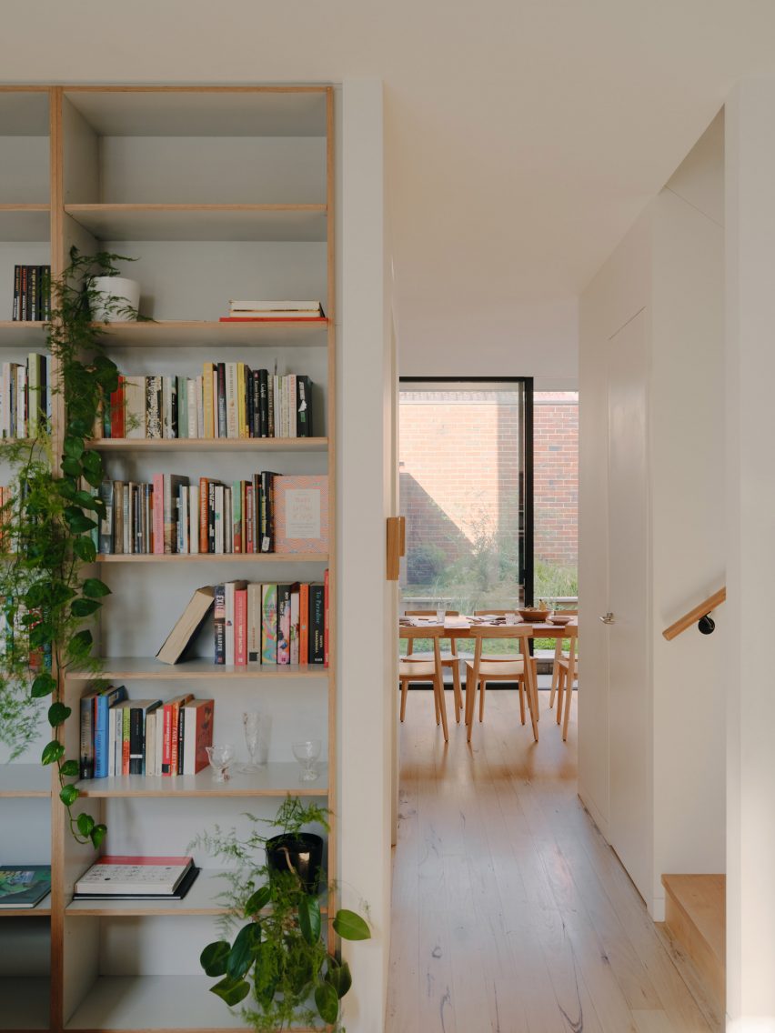 White home interior with wooden bookshelves