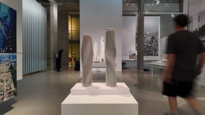 Interior exhibition shot with two tall tower model