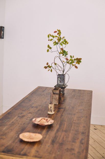 Ceramic plates and vases on table in Mirroring Dialogue exhibition in Brompton Design District for London Design Festival 2025