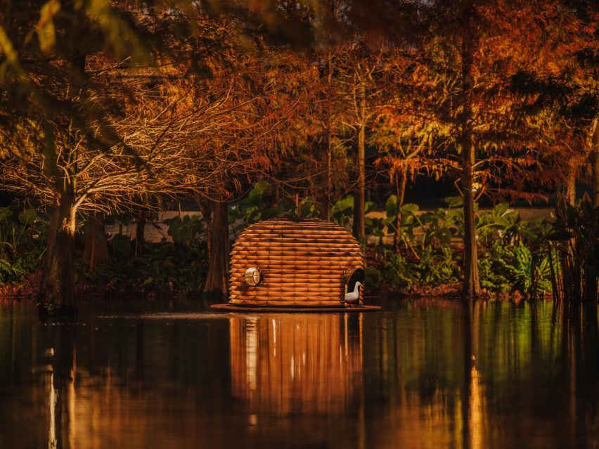 Duck shelter surrounded by trees on pond