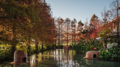Floating wooden pinecone-like huts on pond for ducks