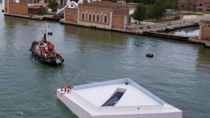 White plaza being towed in Venice