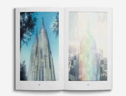 a photograph of an open book with pixelated images printed onto its pages