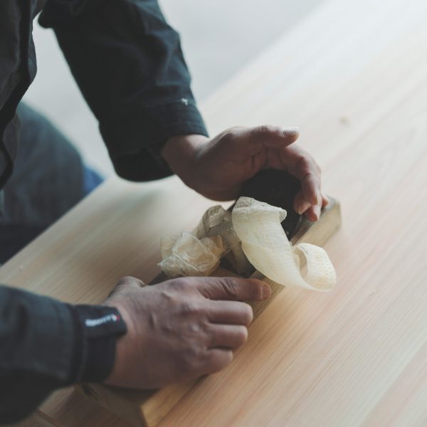 Photo of someone planing wood