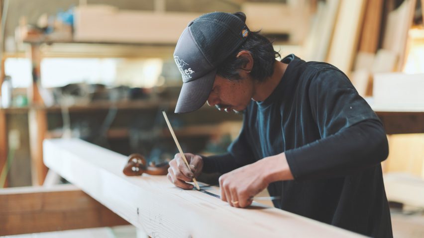 Photo of someone drawing on wood