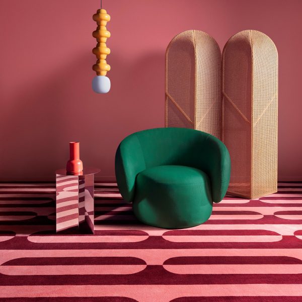 Newstalgia flooring, featuring pink and red carpet and emerald-coloured chair