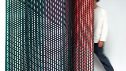 Plissade, a textile-based room divider, in green, blue and red