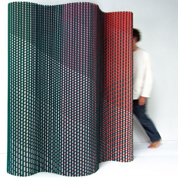 Plissade, a textile-based room divider, in green, blue and red