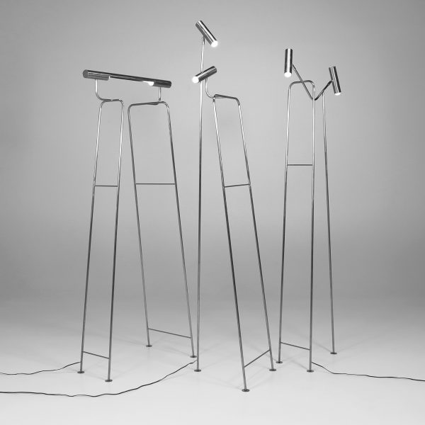 a photograph of silver floor lamps