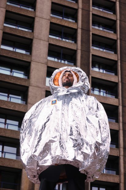 a photograph of a person wearing a silver coat