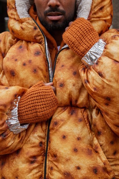 a photo of a person wearing a brown puffer jacket