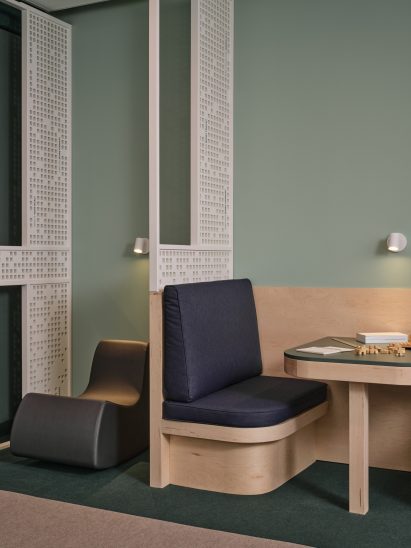 Rocking chair and a banquette seat against a pale green wall