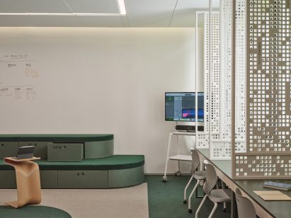 Classroom with green bleachers and white furniture on wheels