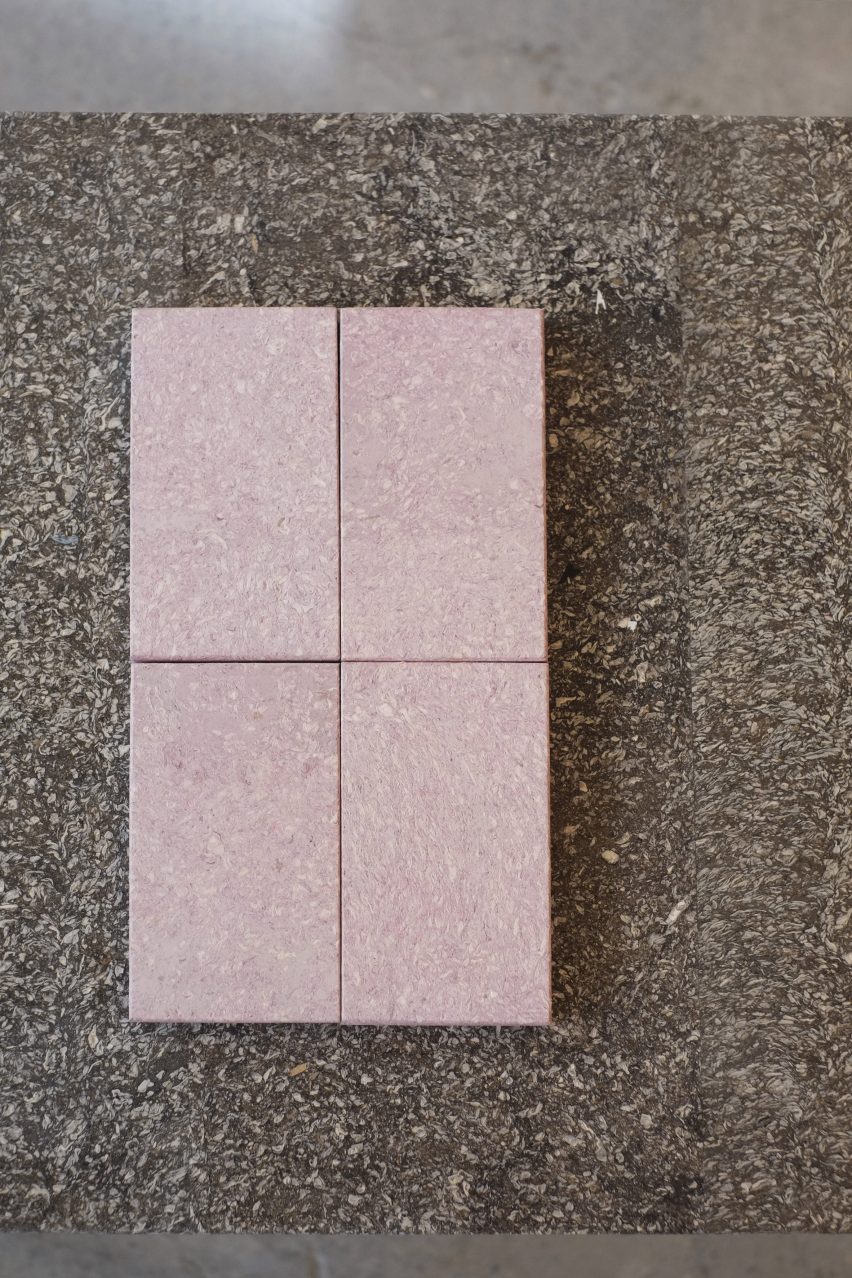 Photo of pale pink samples of Cupsan on a brown tableotp of the same biomaterial