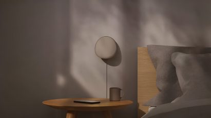 an image showing a wall lamp beside a bed