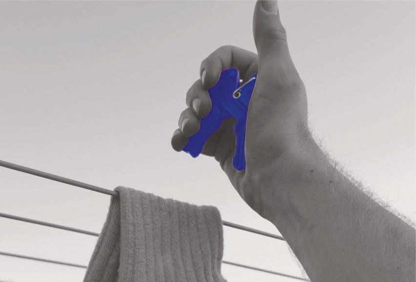 an image of a person's hand holding a blue peg