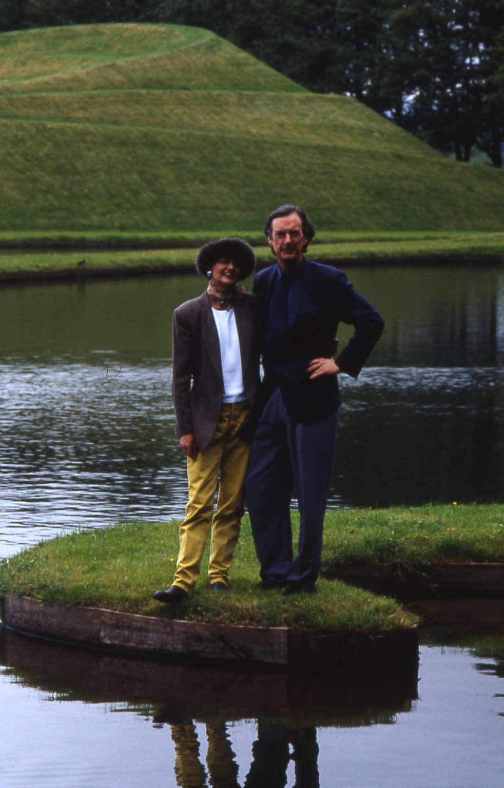 Charles and Maggie standing on an island in a lake.