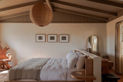 Guest suite with a warm neutral palette and lofted ceiling